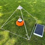 Phipower meditation pyramid on the grass with the frequency device inside