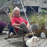 Man relaxing with his dog inside the Phipower meditation pyramid
