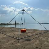 Large meditation pyramid with meditation cushion assembled outdoors on the beach