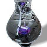 Detail of the illuminated water vortex with violet and blue light
