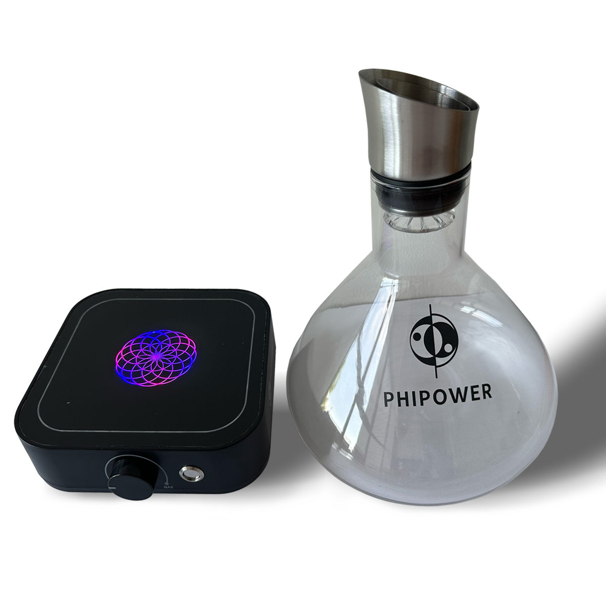 Glass vortex carafe next to the magnetic stirrer with illuminated Lotus of Life
